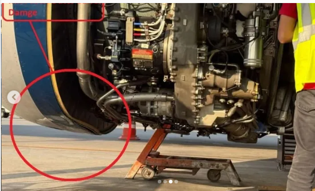 Ground crew inspecting the damaged engine